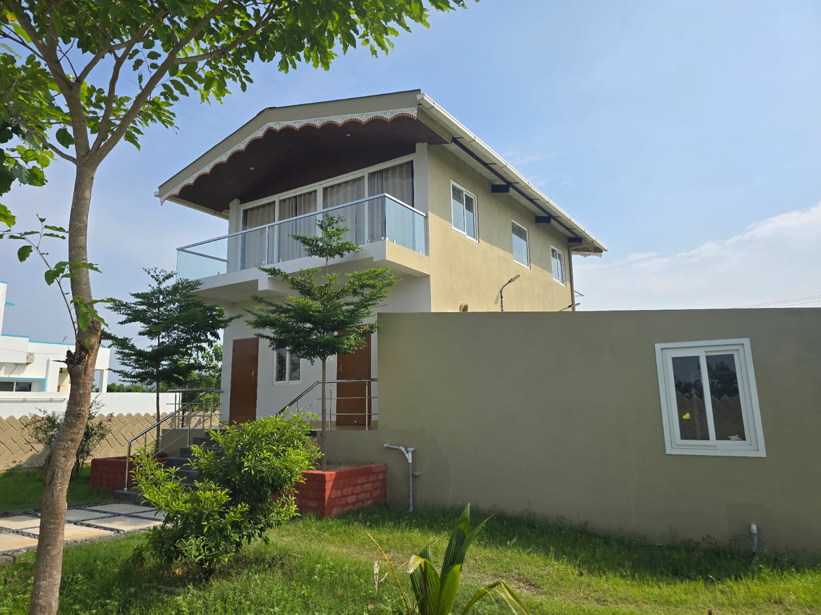 Elegant premium farmhouse surrounded by lush greenery and modern architecture