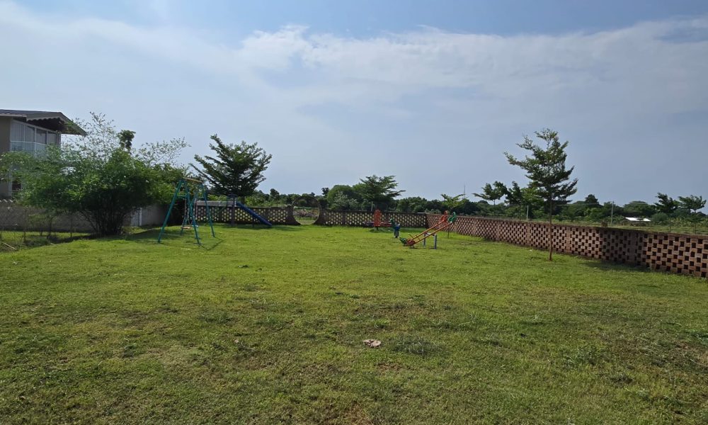 Elegant premium farmhouse surrounded by lush greenery and modern architecture.