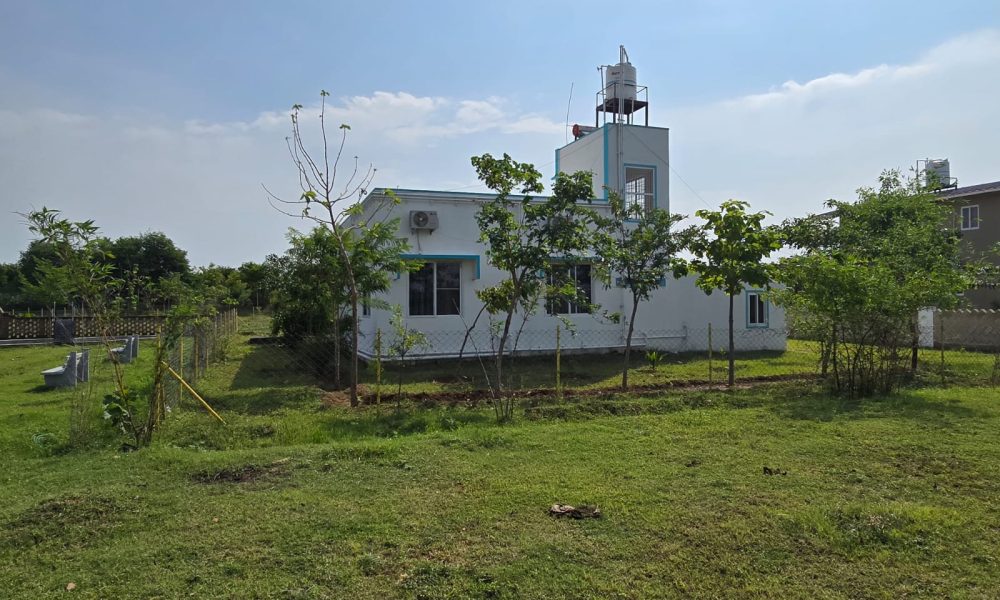 Elegant premium farmhouse surrounded by lush greenery and modern architecture.